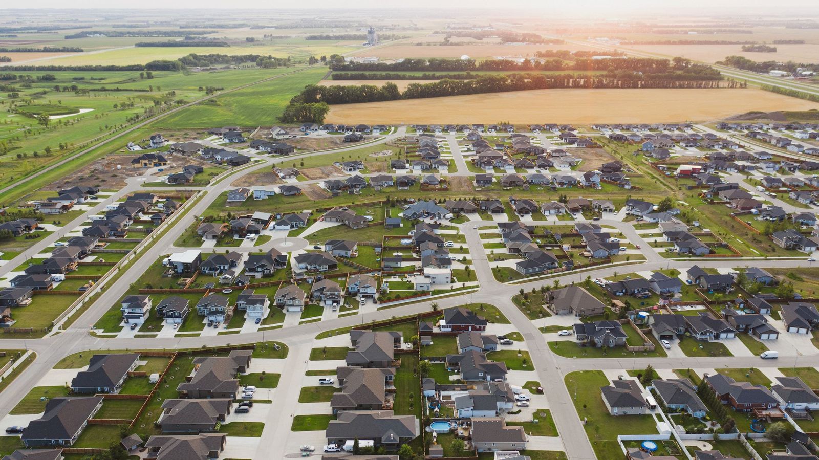 Newer Winkler neighbourhood and surrounding farmland from above at sunset